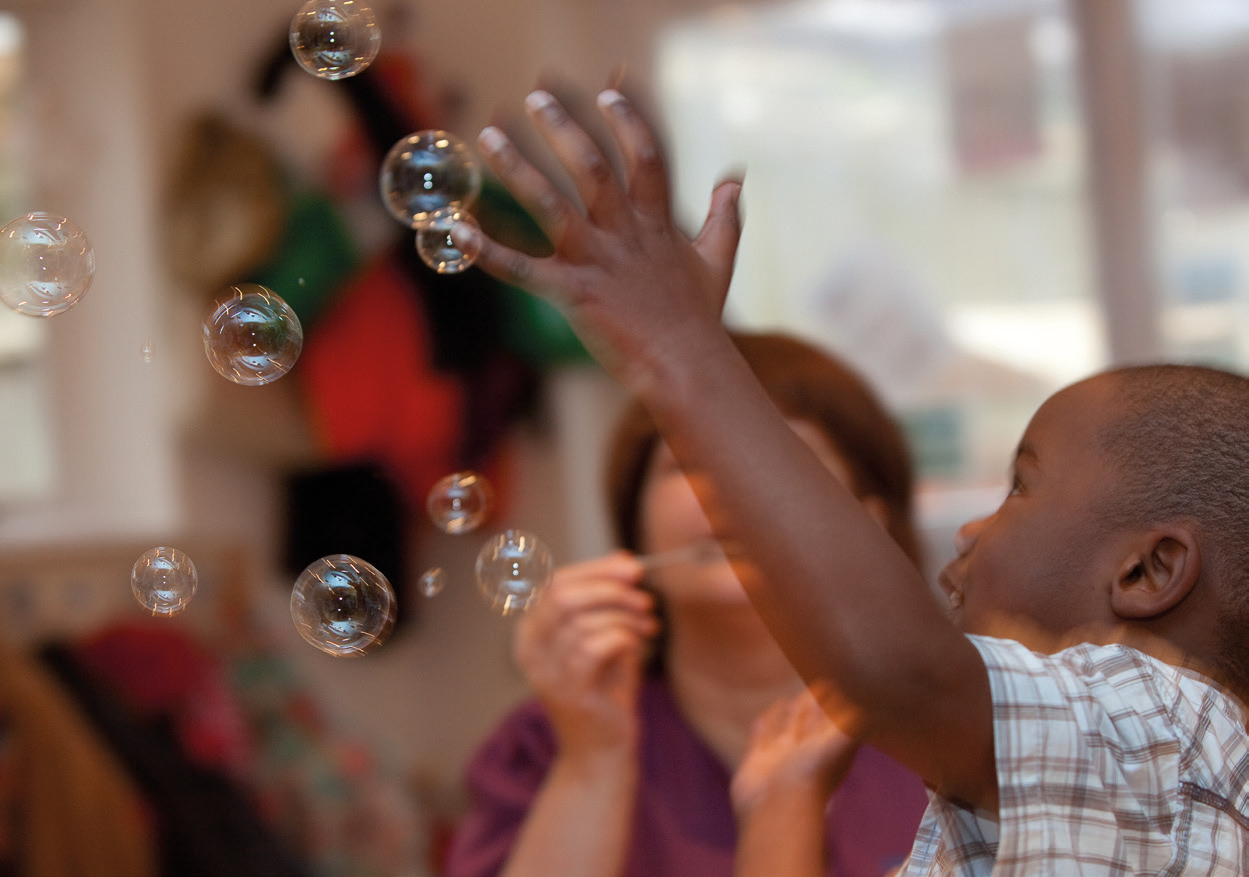 Child playing with bubbles