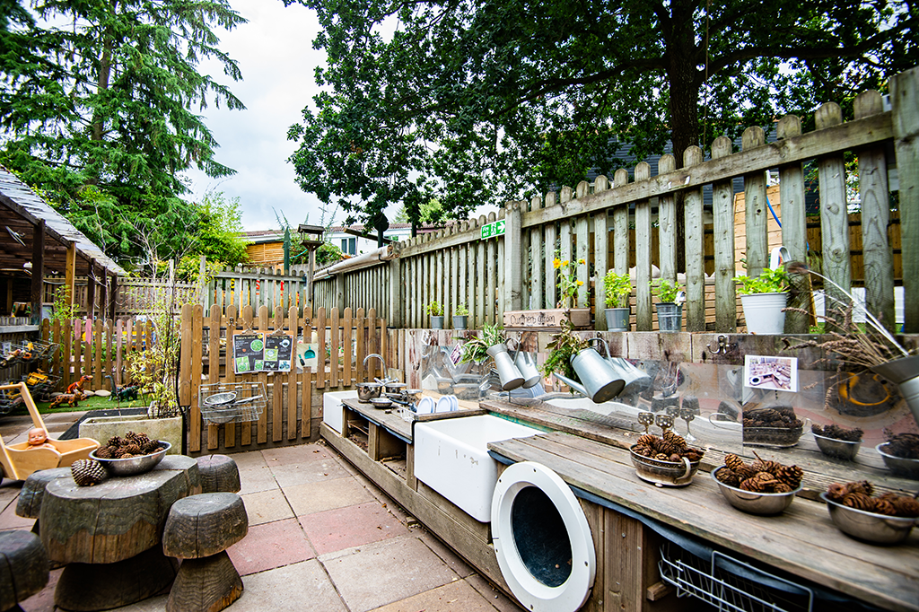 Outdoor play area with pots and plants
